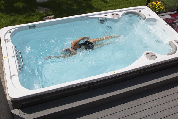 Athlete swimming in an affordable swim spa
